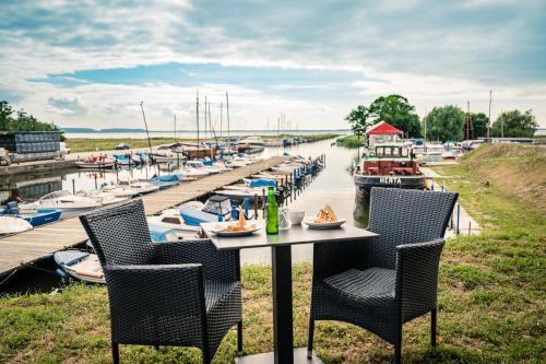 a table with chairs and drinks on it next to a marina at Marina Martinshafen - Beach life in Sassnitz