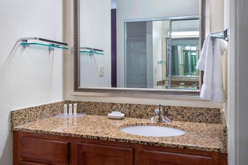a bathroom with a sink and a large mirror at Residence Inn Cranbury South Brunswick in Cranbury
