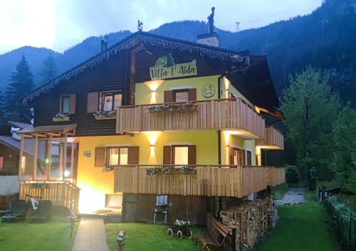 a building with a sign on the side of it at Villa L'Aida in Canazei