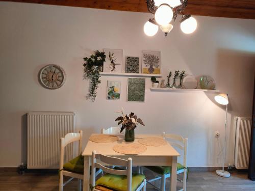 a dining room with a table and chairs at Armonia & Anemos Family Apartments in Kálamos