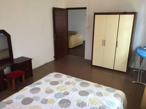 a bedroom with a bed and a dresser and a mirror at Modern and Cozy Apartment in Quatre Bornes in Quatre Bornes