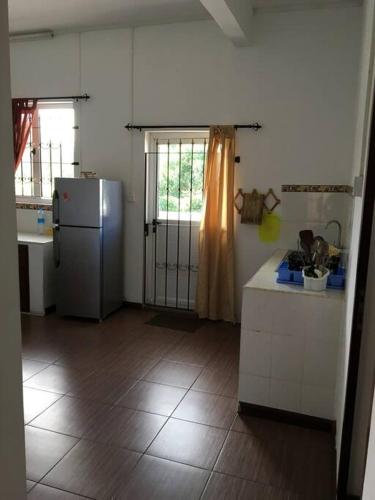 a kitchen with a refrigerator and a counter in it at Modern and Cozy Apartment in Quatre Bornes in Quatre Bornes