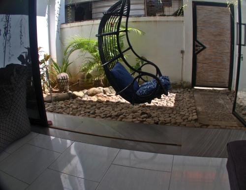 a swing in the middle of a garden at 3 Waves Hotel in Huu