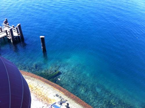 an aerial view of the blue ocean with a pier at -Ortaflats- Appartamento l'Isola in Orta San Giulio