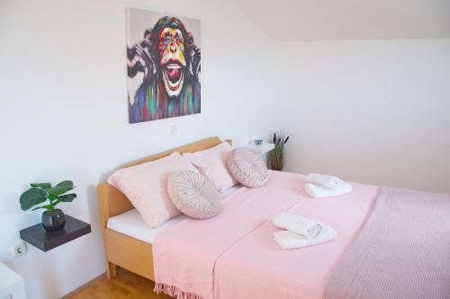 a bedroom with a bed with two towels on it at Apartments Summersong in Novalja