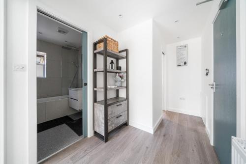 a bathroom with a mirror and a walk in shower at Newly Refurbished 2 Bed Flat in Mill Hill