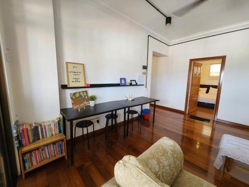 a living room with a table and a chair at Jen Homestay in Kuala Terengganu