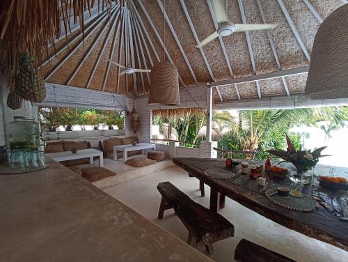 a living room with a table and a dining area at Sal Secret Spot in Uluwatu
