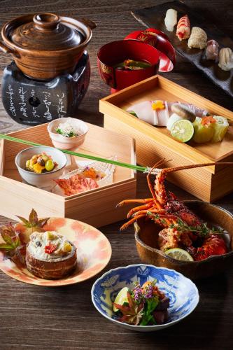 a table topped with plates of food and boxes of food at ITSUKUSHIMA IROHA in Miyajima