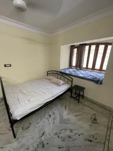 Ένα ή περισσότερα κρεβάτια σε δωμάτιο στο Pushpanand Guest House