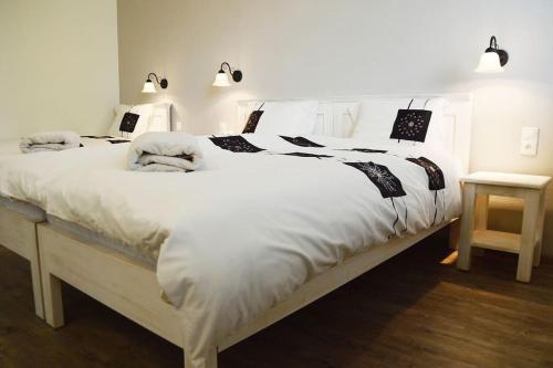 a bedroom with a large white bed with white sheets at Kipi Casa Family Apartment 3+2 with living room in Lazany