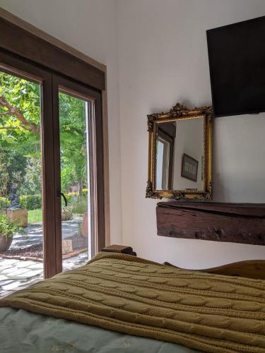 a bedroom with a bed and a mirror on the wall at Casa Rural Bilbao Caserio Gondra Alquiler Habitaciones in Mungia