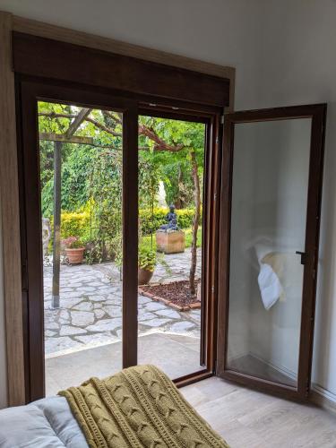 a bedroom with a sliding glass door to a patio at Casa Rural Bilbao Caserio Gondra Alquiler Habitaciones in Mungia