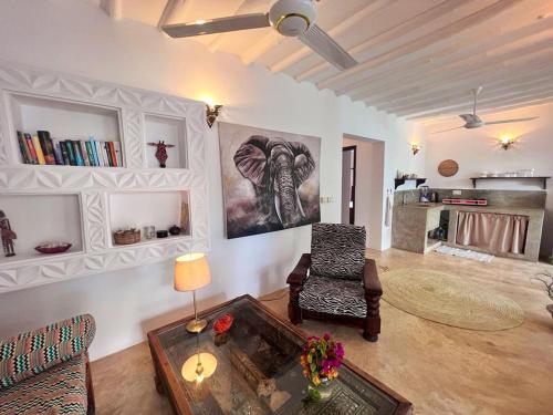 a living room with a chair and a table at MOYO apartment in Pwani Mchangani