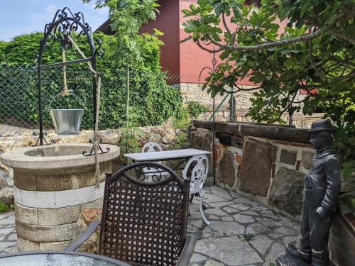 a statue of a man sitting next to a fountain at Casa Rural Bilbao Caserio Gondra Alquiler Habitaciones in Mungia
