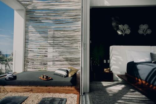 a bedroom with a bed and a large window at TULUM Beachfront Villa I'Ik by Casa Xuul Tulum in Tulum