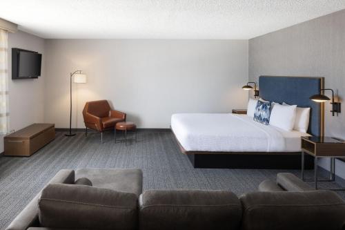 a hotel room with a bed and a couch at Courtyard Santa Fe in Santa Fe