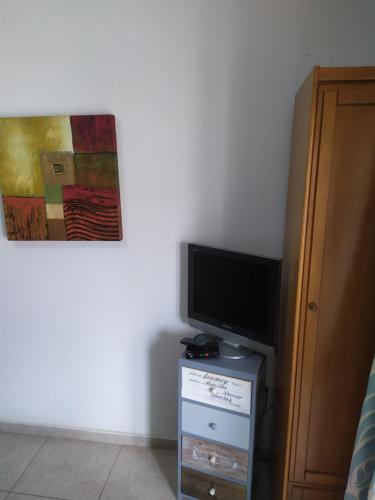 a flat screen tv sitting on top of a dresser at Tzikas apARTments in Thessaloniki