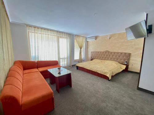 une chambre d'hôtel avec un canapé et un lit dans l'établissement Hotel The Golden fish, à Sozopol