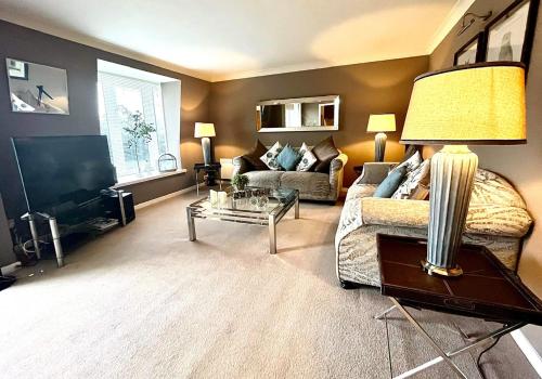 a living room with a couch and a table at Gleneagles Lettings in Auchterarder