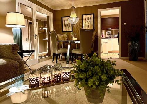 a living room with a vase of flowers on a glass table at Gleneagles Lettings in Auchterarder