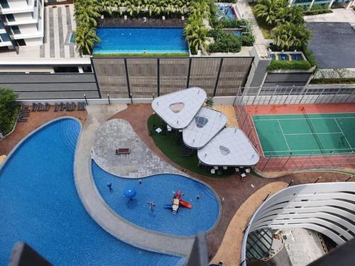 an overhead view of a swimming pool in a city at Cozy 3 Guests High Floor at Puteri Harbour L22 in Nusajaya