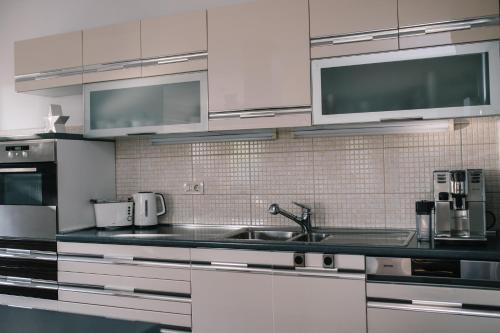 a kitchen with white cabinets and a sink at Ferienhaus in Široki Brijeg