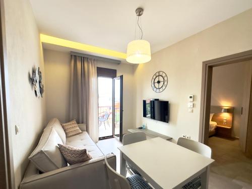 a living room with a couch and a table at Yulia Luxury Apartment in Ouranoupoli