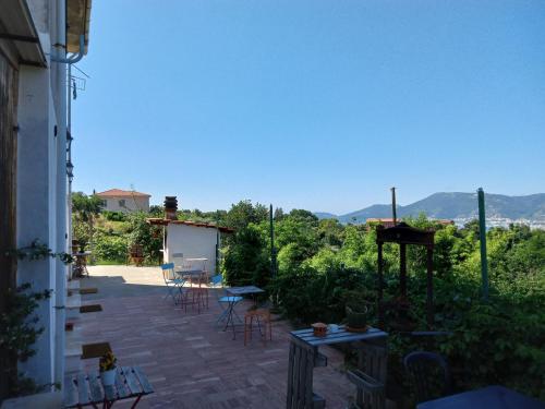 a patio with chairs and tables and a view at In campagna in La Spezia