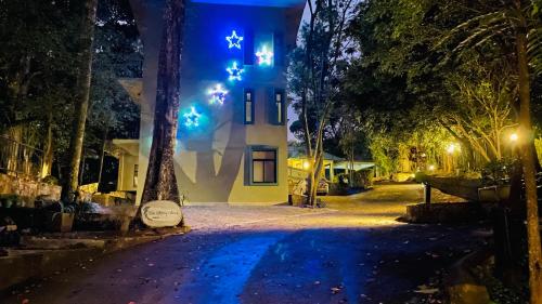 a house at night with blue lights on a street at Spring Villas Kandy in Kandy