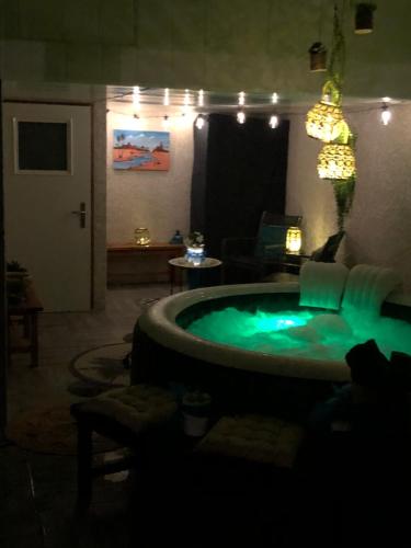 a room with a jacuzzi tub in a living room at Anexxe in Coutouvre