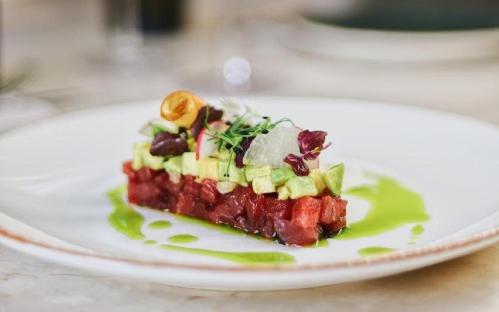 a piece of food on a plate on a table at Shepherd Hotel in Amman