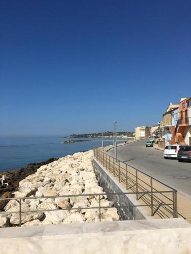 a bridge over a body of water next to a street at Mare Azzurro Appartamento in Sciacca