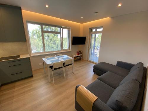 a living room with a couch and a table at Urbas Sea view apartments in Nida