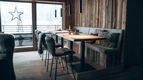 a dining room with a table and chairs and a window at Mountain See Lodge in See