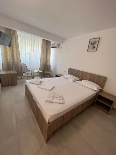 a bedroom with a large bed in a room at Complex Marea Neagra in Eforie Nord
