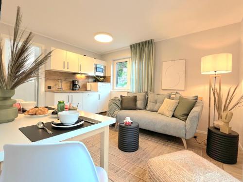 ein Wohnzimmer mit einem Sofa und einem Tisch in der Unterkunft Maison Saarschleife Mettlach in Mettlach