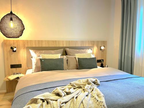 a bedroom with a large bed with a blanket on it at Maison Saarschleife Mettlach in Mettlach