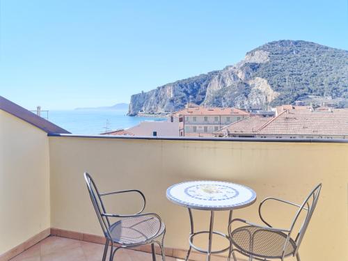 a table and chairs on a balcony with a view of the ocean at Hotel Medusa in Finale Ligure