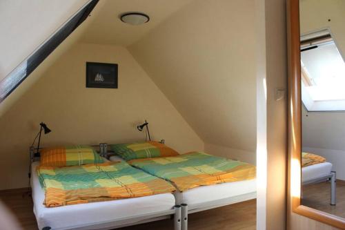a bedroom with a bed in a attic at Müritzbrise in Sietow