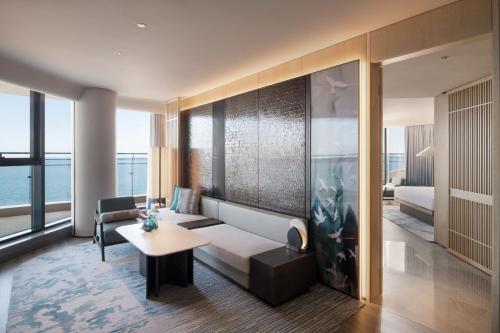 a living room with a couch and a table at Qinhuangdao Marriott Resort in Qinhuangdao