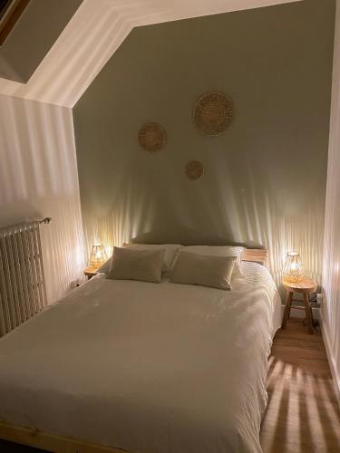 une chambre avec un grand lit blanc avec deux lampes dans l'établissement Doumer - appartement - 63m2 - 6pers, à Cholet