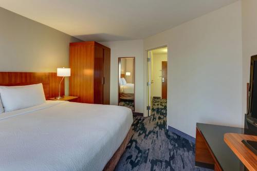 a hotel room with a bed and a television at Fairfield Inn & Suites by Marriott Fort Worth I-30 West Near NAS JRB in Fort Worth