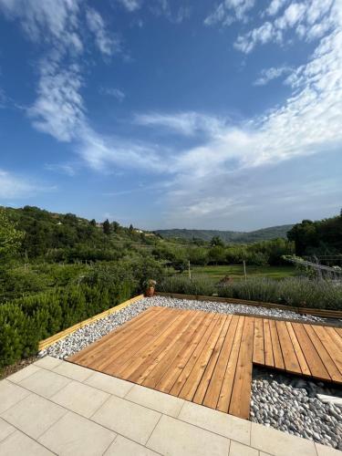 a wooden deck with a view of a field at Luna di Rose in Portorož