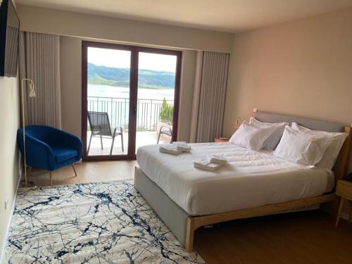 a bedroom with a large bed and a balcony at Belas Vistas Hotel in Montalegre