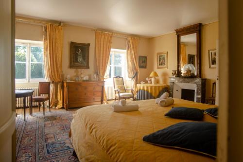 a bedroom with a large bed with two pillows on it at Chateau de Rhodes in La Bastide-de-Sérou