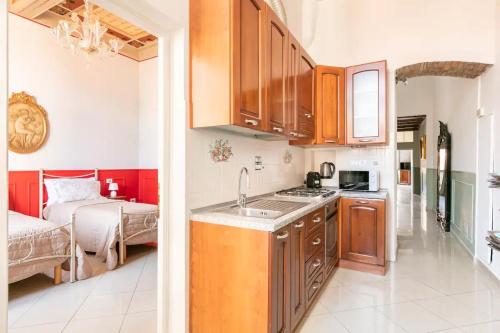 a kitchen with a sink and a bedroom with a bed at Appartamento Sant'Ambrogio in Florence