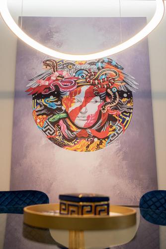 a painting on the wall of a room with a table at Aire in Tripolis