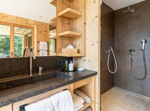 a bathroom with a large sink and a shower at Chalet Residenz Zillertal Mühlermoos in Ramsau im Zillertal