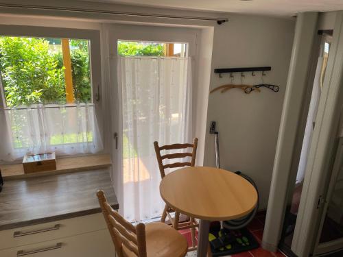 a kitchen with a table and chairs and a window at Alpenpanorama in Weilheim in Oberbayern